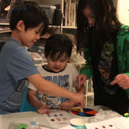 Two boys and a girl doing I Luv Chinese crafts.